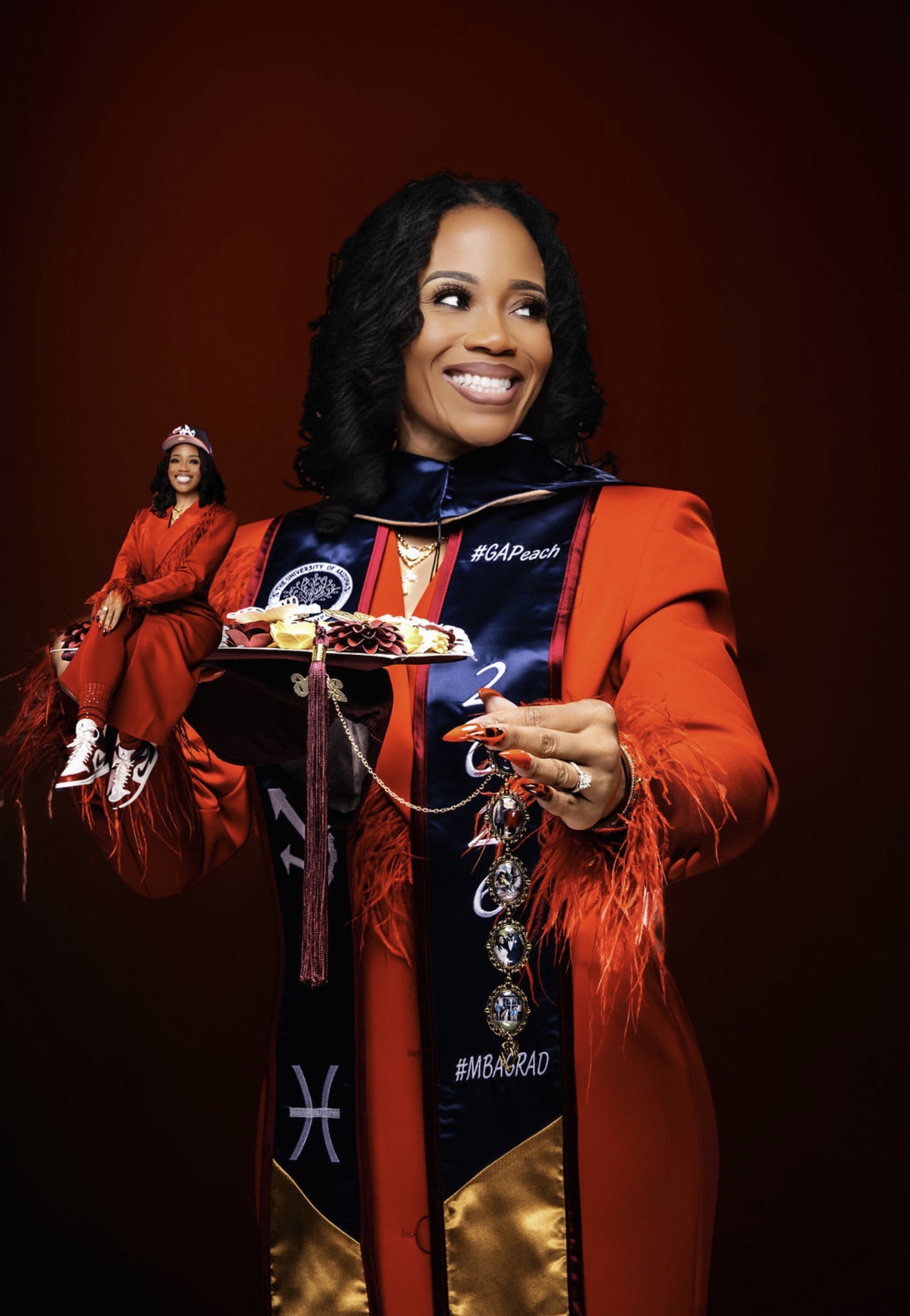 Leonia Moore in red academic regalia, smiling and holding her graduation cap
