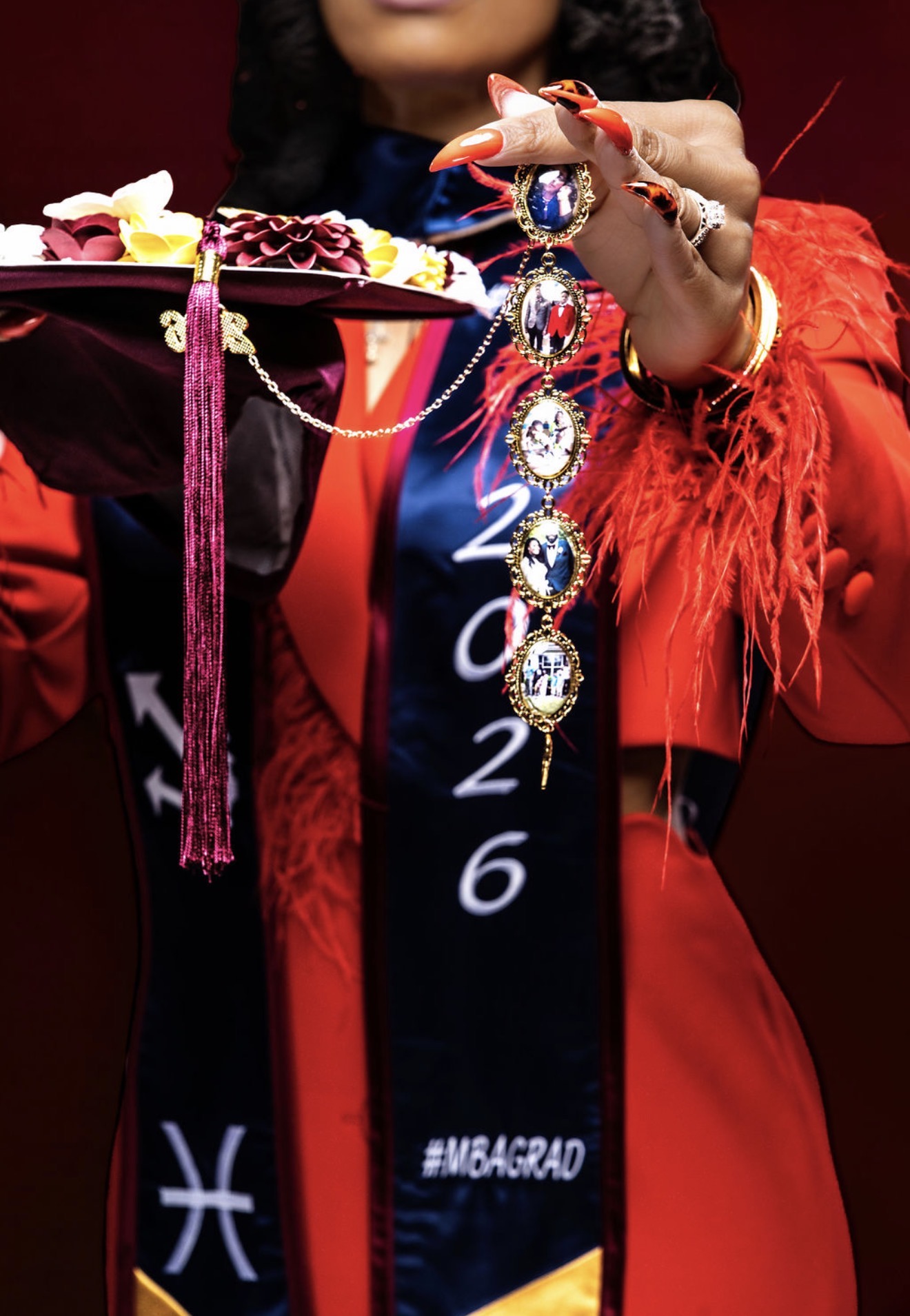 Close-up of Leonia Moore holding her decorated graduation cap and family keepsake